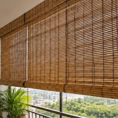 Natural roll-up bamboo blinds shading an Indian apartment balcony