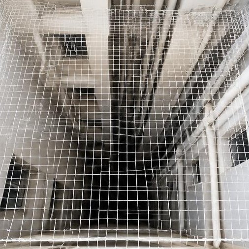 Protective mesh installed across an apartment utility duct shaft
