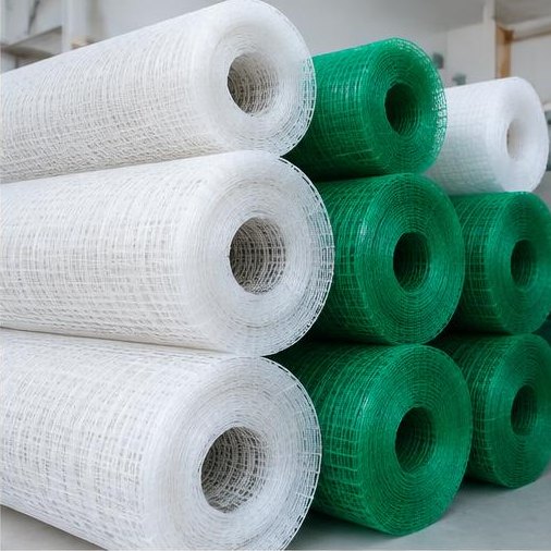 Rolls of white and green safety mesh ready for supply