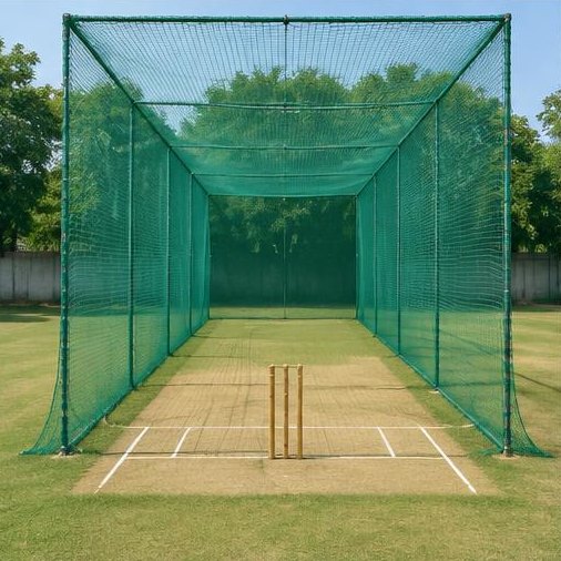 Green cricket practice net enclosure with pitch and wickets